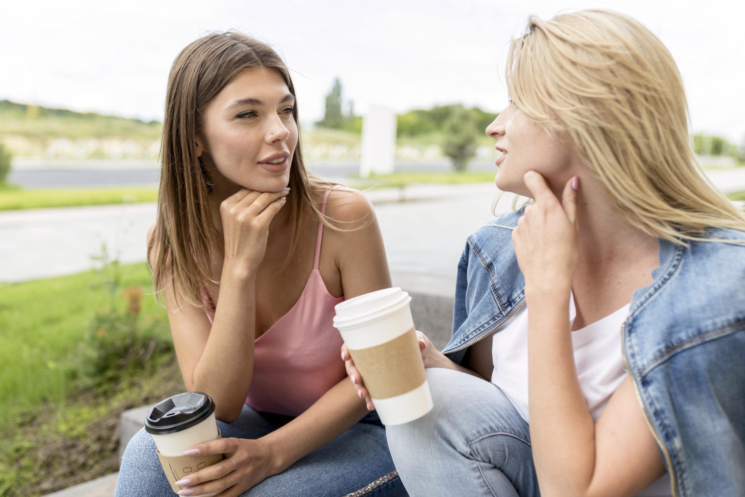 front-view-best-friends-holding-some-paper-cups-coffee